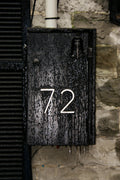 A weathered metal box displays the number 72.