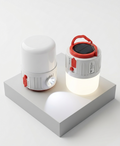 Two white and red portable lamps on a white platform with a white background