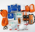 Collection of emergency supplies including a rope, water packets, a tent, radios, and medical kits on a white background.